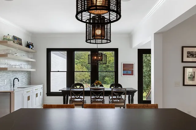 a view of a bedroom with wooden floor and windows