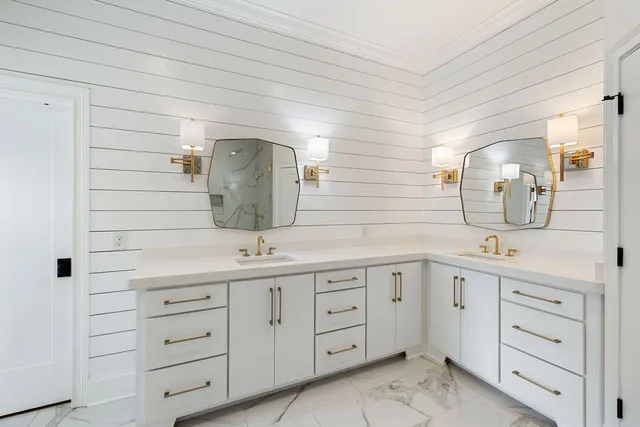 a spacious bathroom with a double vanity sink mirror and double