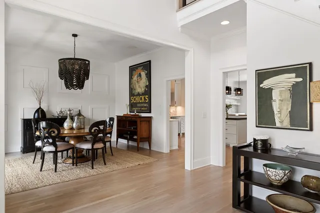 a dining room with furniture and wooden floor