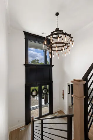 a kitchen with stainless steel appliances granite countertop a lot of counter space dining table and chairs