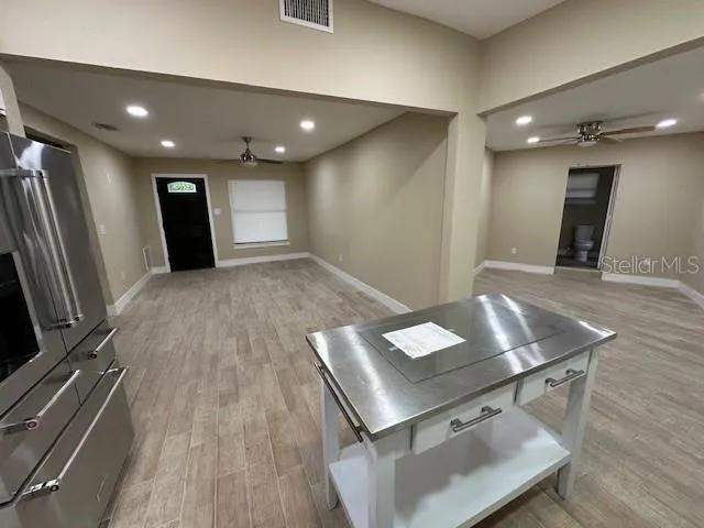 a view of kitchen with a sink and a refrigerator