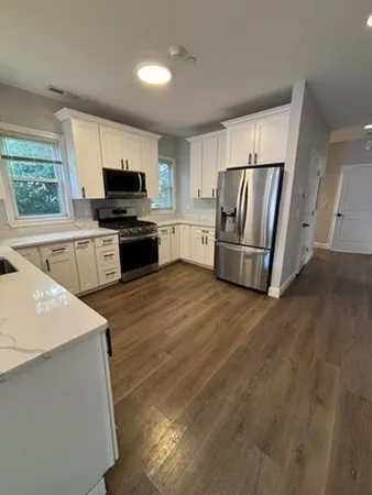 a kitchen with a refrigerator a stove top oven a sink and dishwasher