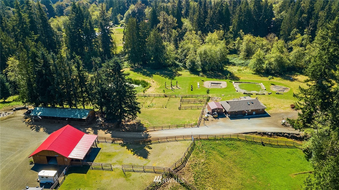 12105 Ingraham Road Snohomish, WA 98290 - Photo 3 of 30 an aerial view of a house with swimming pool and large trees