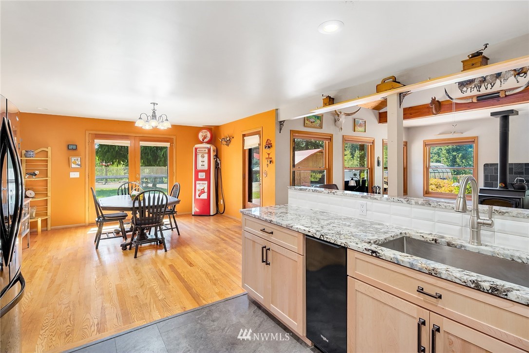 12105 Ingraham Road Snohomish, WA 98290 - Photo 10 of 30 a kitchen with stainless steel appliances granite countertop a stove and a wooden floors