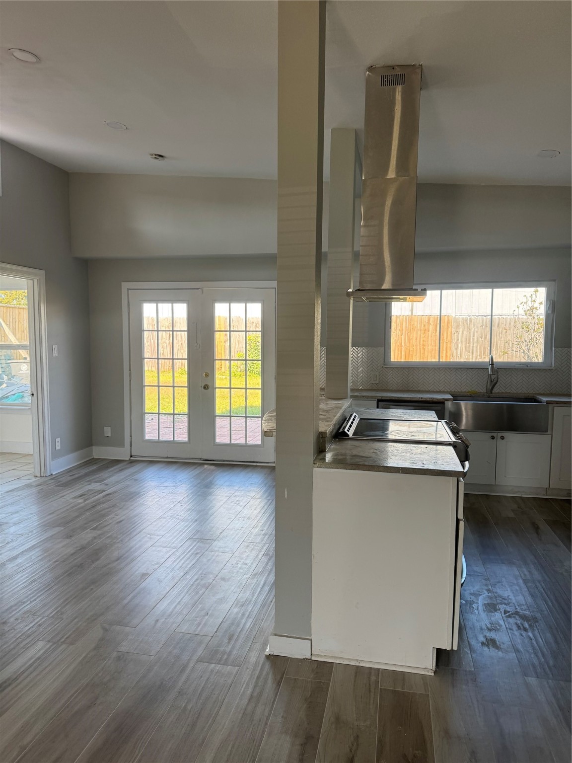 7526 Dearborn Street Houston, TX 77055 - Photo 3 of 11 a view of a kitchen with a sink and dishwasher a refrigerator with wooden floor