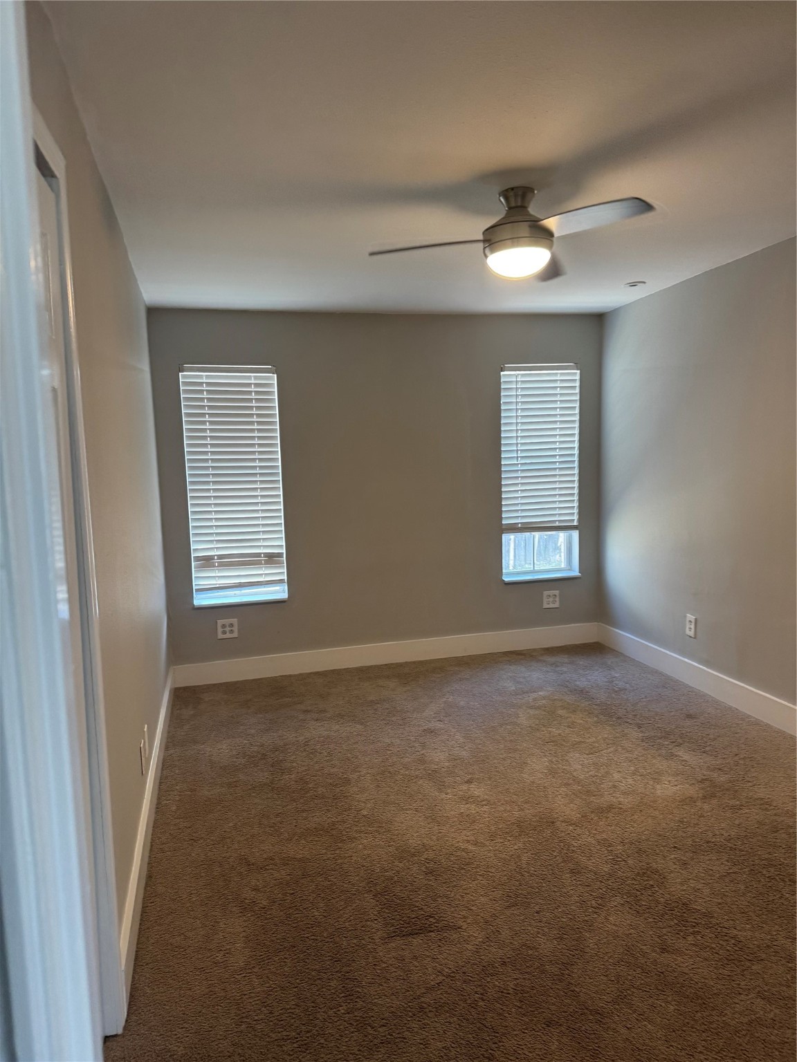 7526 Dearborn Street Houston, TX 77055 - Photo 5 of 11 an empty room with windows and fan