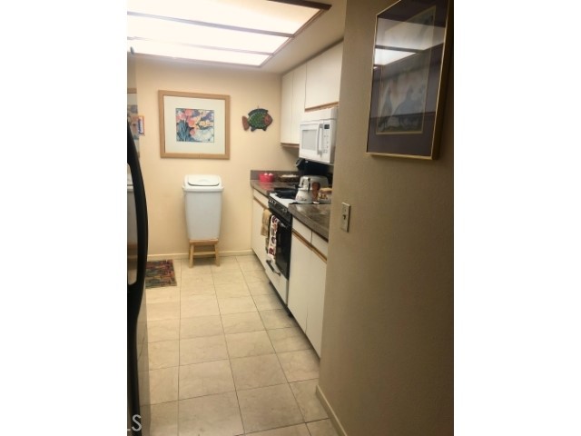 200 East Racquet Club Road, Unit 19 Palm Springs, CA 92262 - Photo 6 of 21 a kitchen with a sink and a stove top oven