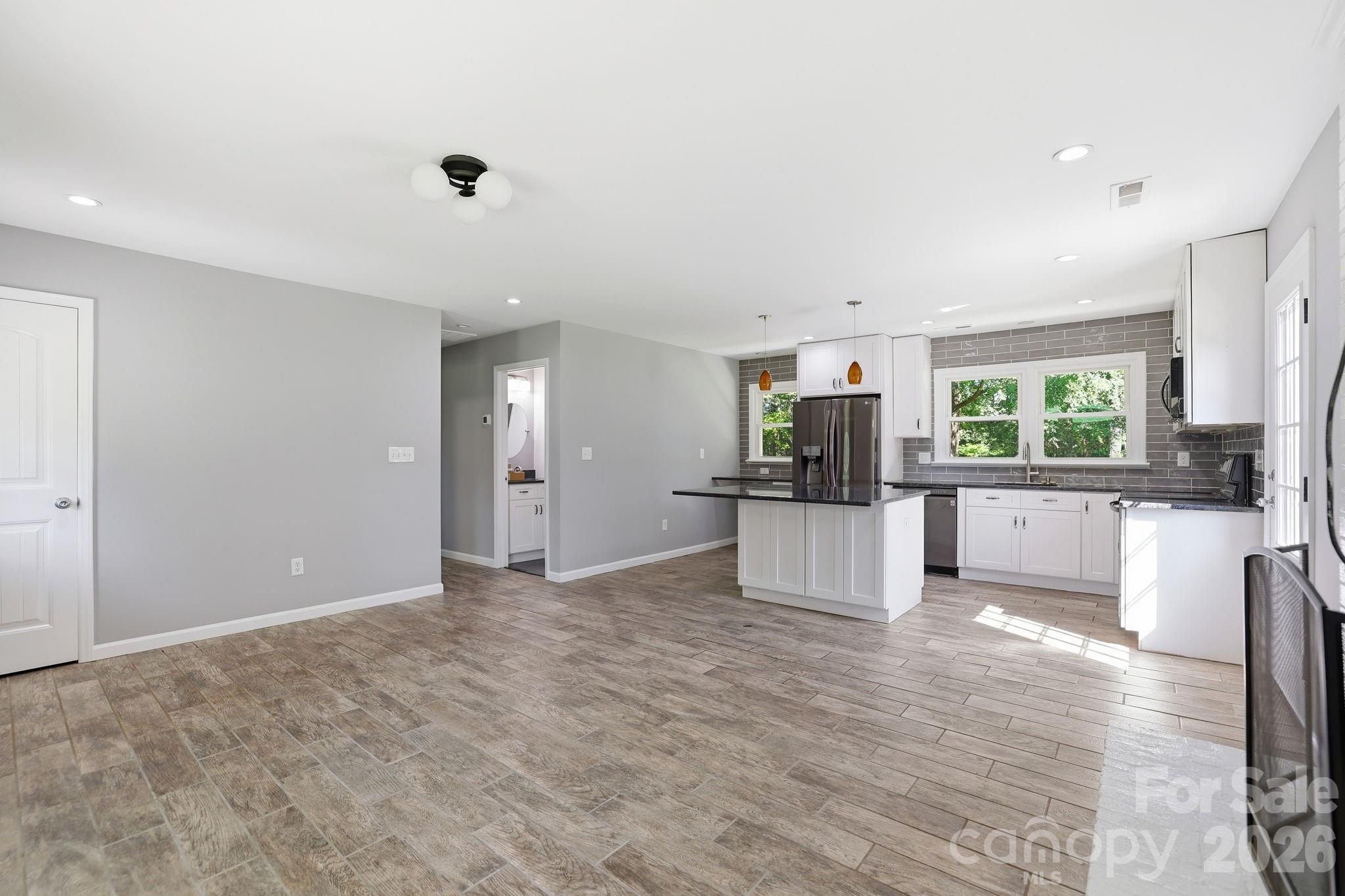 1108 Willoughby Road Monroe, NC 28110 - Photo 21 of 48 a view of a kitchen with kitchen island stainless steel appliances refrigerator oven and cabinets