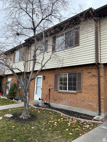 939 South Freedom Boulevard, Unit 13 Provo, UT 84601 - Photo 3 of 26 Colonial-style house with a front lawn and brick siding
