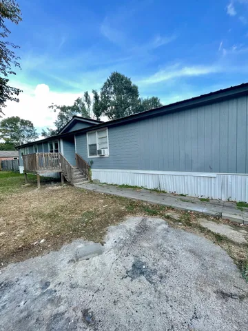 a view of a backyard with a large tree