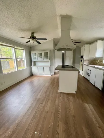 a view of a kitchen with microwave and cabinets