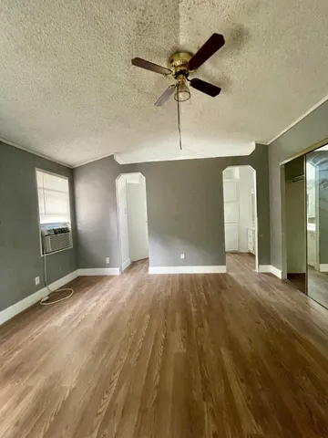 an empty room with a empty space and windows