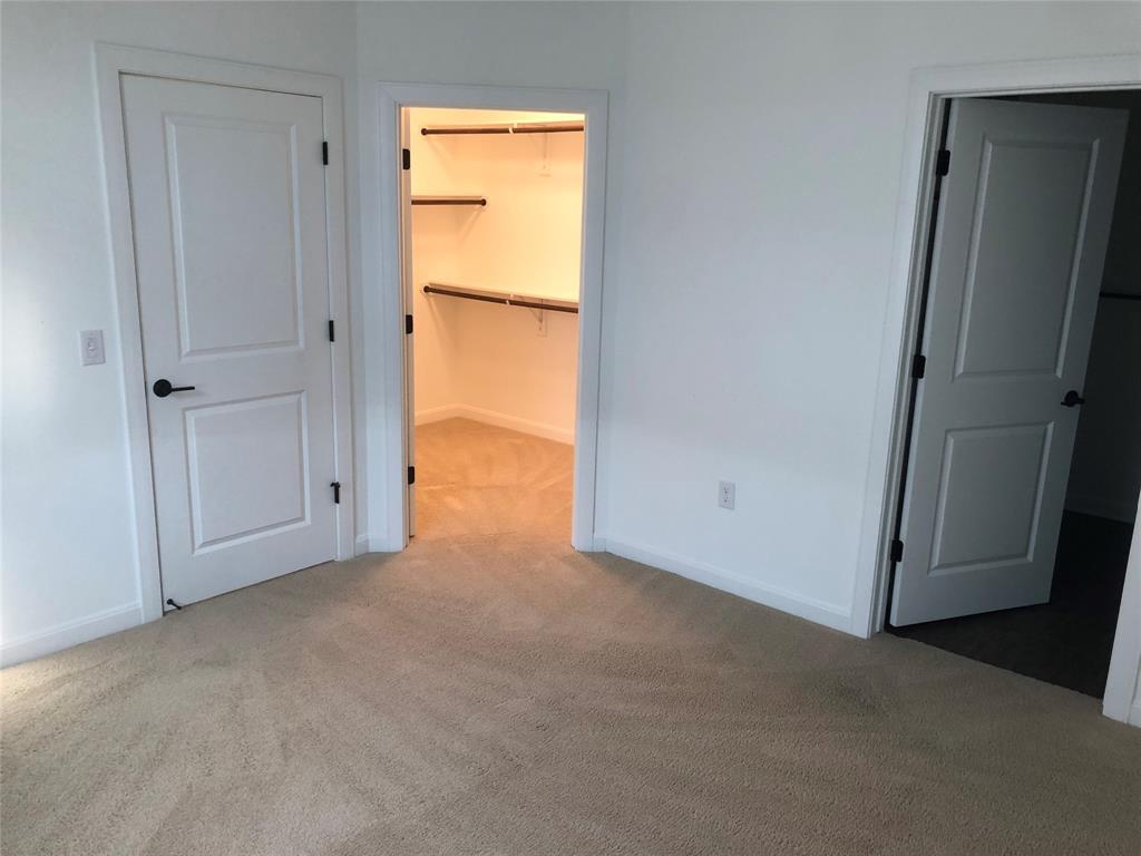 a view of an empty room with a closet