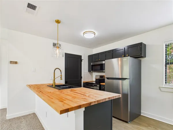 a kitchen with a refrigerator a sink and a refrigerator