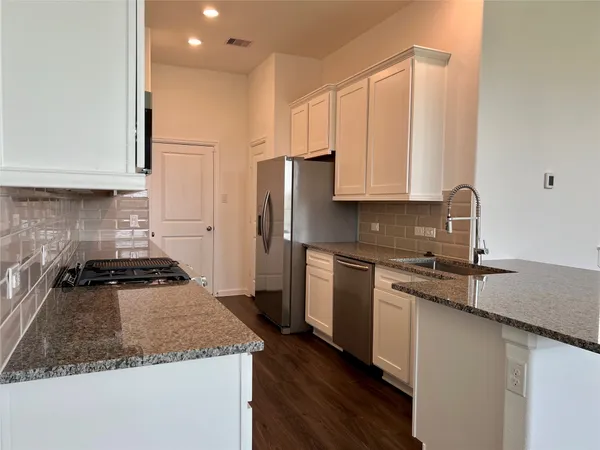 a kitchen with a sink stove and refrigerator