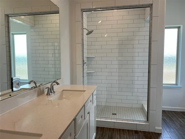 a bathroom with a shower and a sink
