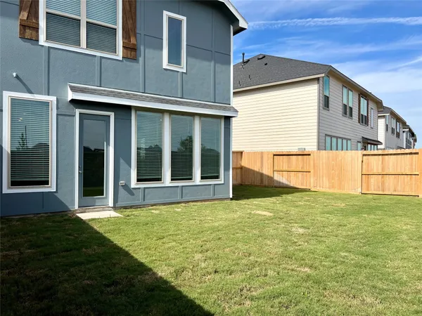 a view of a house with pool and yard