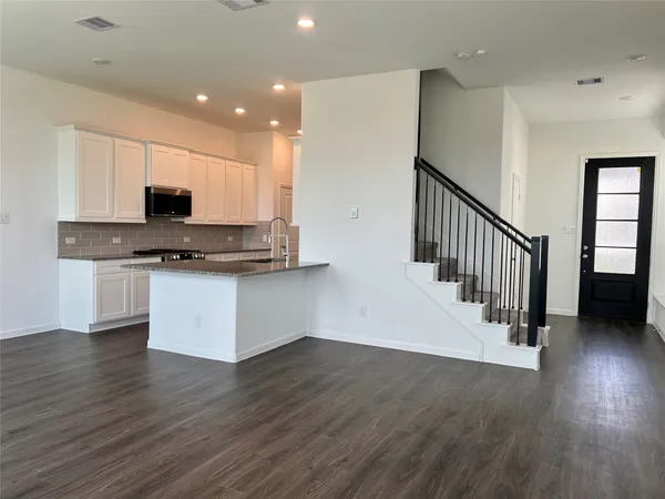 a kitchen with stainless steel appliances a microwave a stove a sink and a microwave