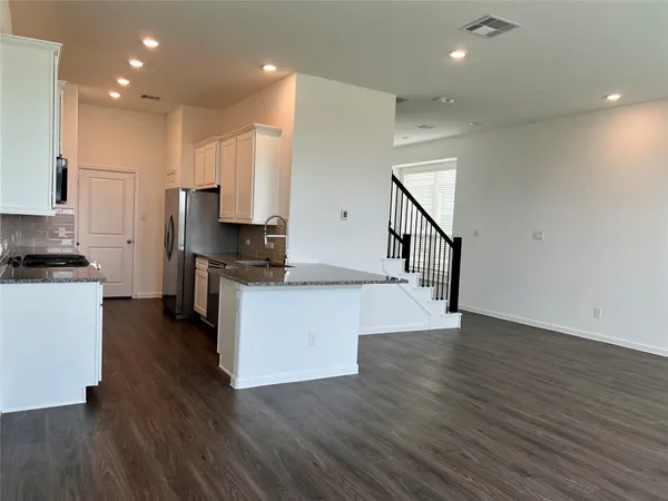 a view of kitchen with sink microwave and stove
