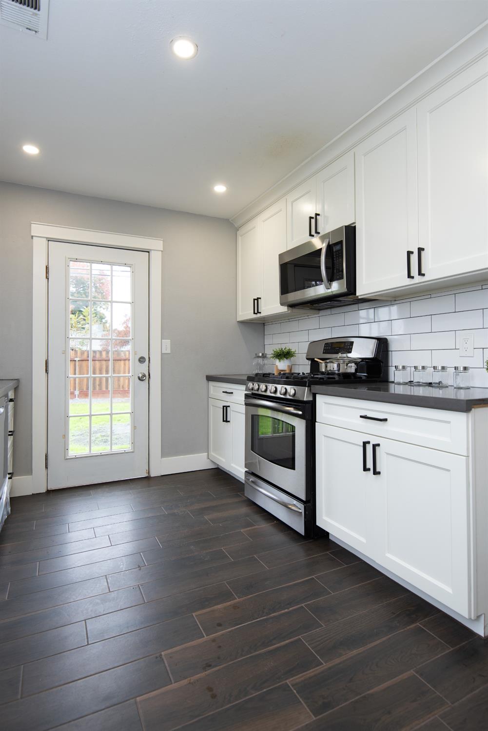 1405 Del Monte Avenue Modesto, CA 95350 - Photo 22 of 45 a kitchen with stainless steel appliances granite countertop a stove a sink and a microwave