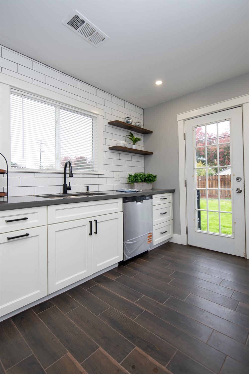 1405 Del Monte Avenue Modesto, CA 95350 - Photo 23 of 45 a kitchen with a sink cabinets and window