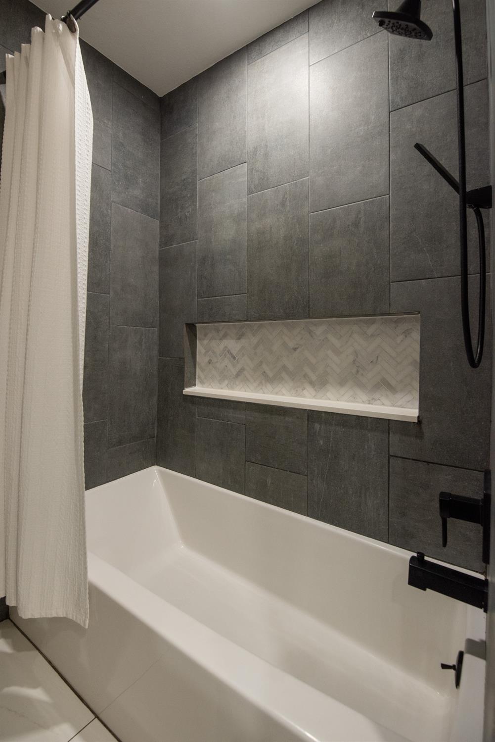 1405 Del Monte Avenue Modesto, CA 95350 - Photo 38 of 45 a bathroom with a bathtub and shower