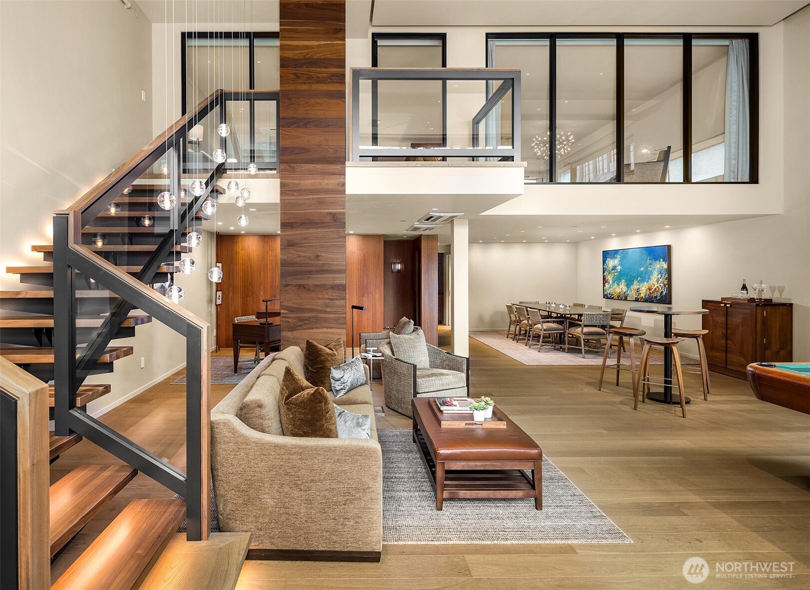 a living room with couches a dining table with rug