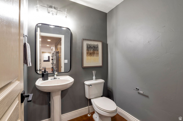577 South Ridge Top Lane East North Salt Lake, UT 84054 - Photo 23 of 57 Convenient main-level powder room for guests, featuring a pedestal sink and a wall-mounted mirror.