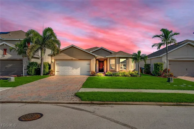 a front view of a house with a yard and garage