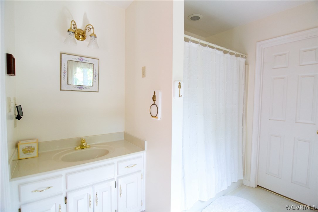 1343 Old Ridge Road Farmville, VA 23901 - Photo 28 of 31 a bathroom with a granite countertop sink a mirror and a shower