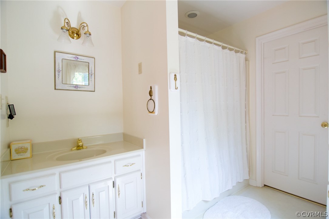 1343 Old Ridge Road Farmville, VA 23901 - Photo 29 of 31 a bathroom with a granite countertop sink a mirror a shower and a sink