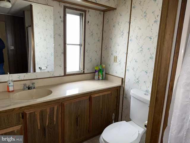 a view of wooden floor and windows in a room
