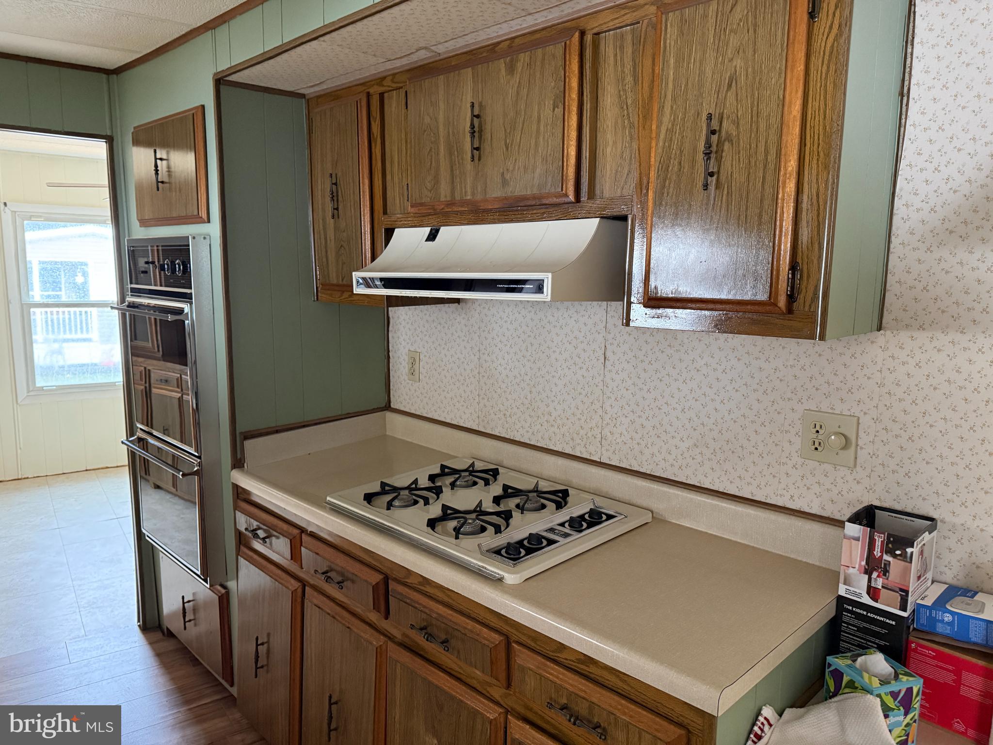 187 Rita Place Williamstown, NJ 08094 - Photo 10 of 20 a kitchen with wooden cabinets and a stove top oven