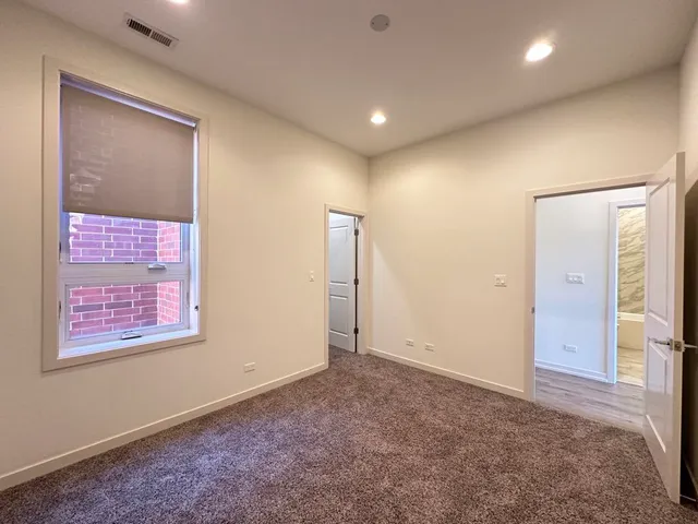 an empty room with windows and closet