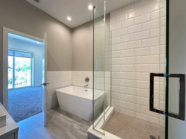 a bathroom with a bathtub and shower