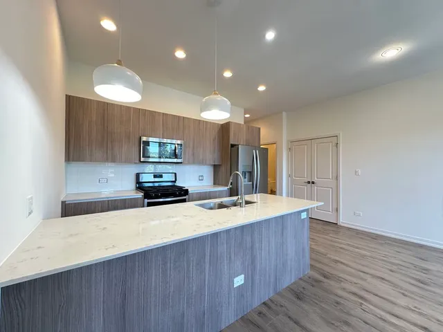 a kitchen with a sink stainless steel appliances and cabinets