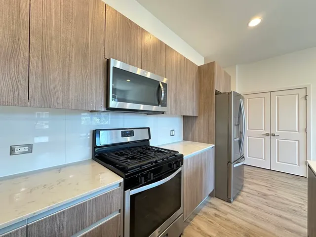 a kitchen with a stove a microwave and refrigerator