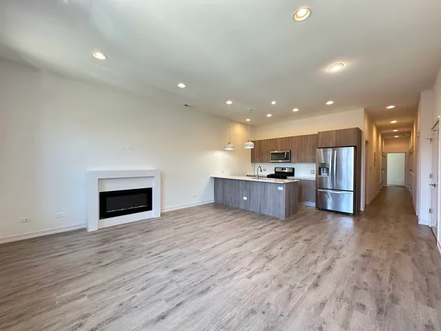 a view of kitchen with kitchen island microwave and stove