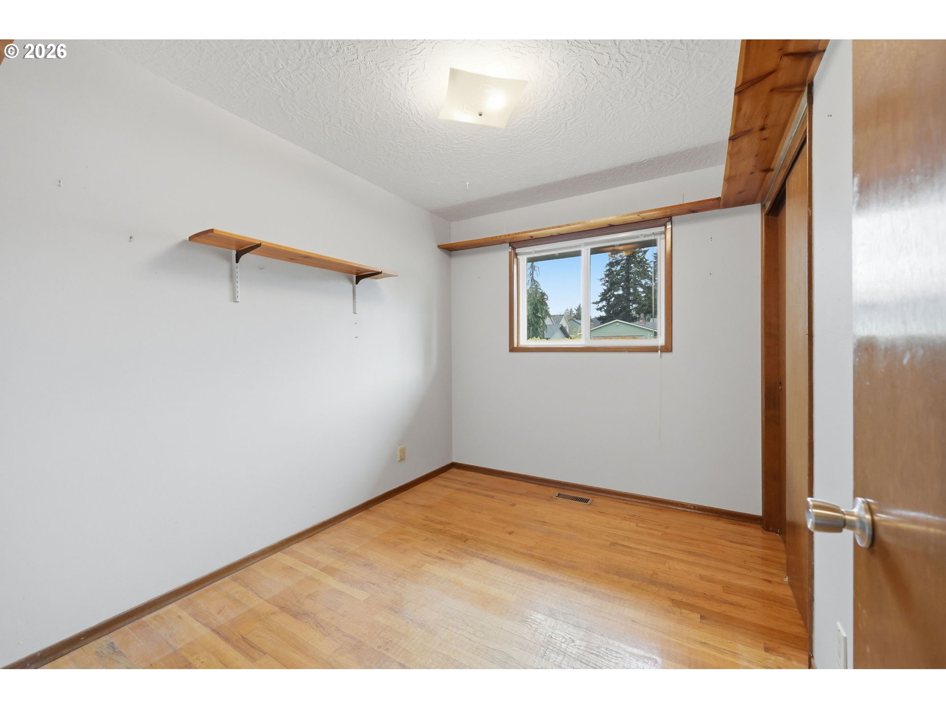 18925 Southwest Rosa Road Beaverton, OR 97078 - Photo 13 of 33 a view of an empty room with wooden floor