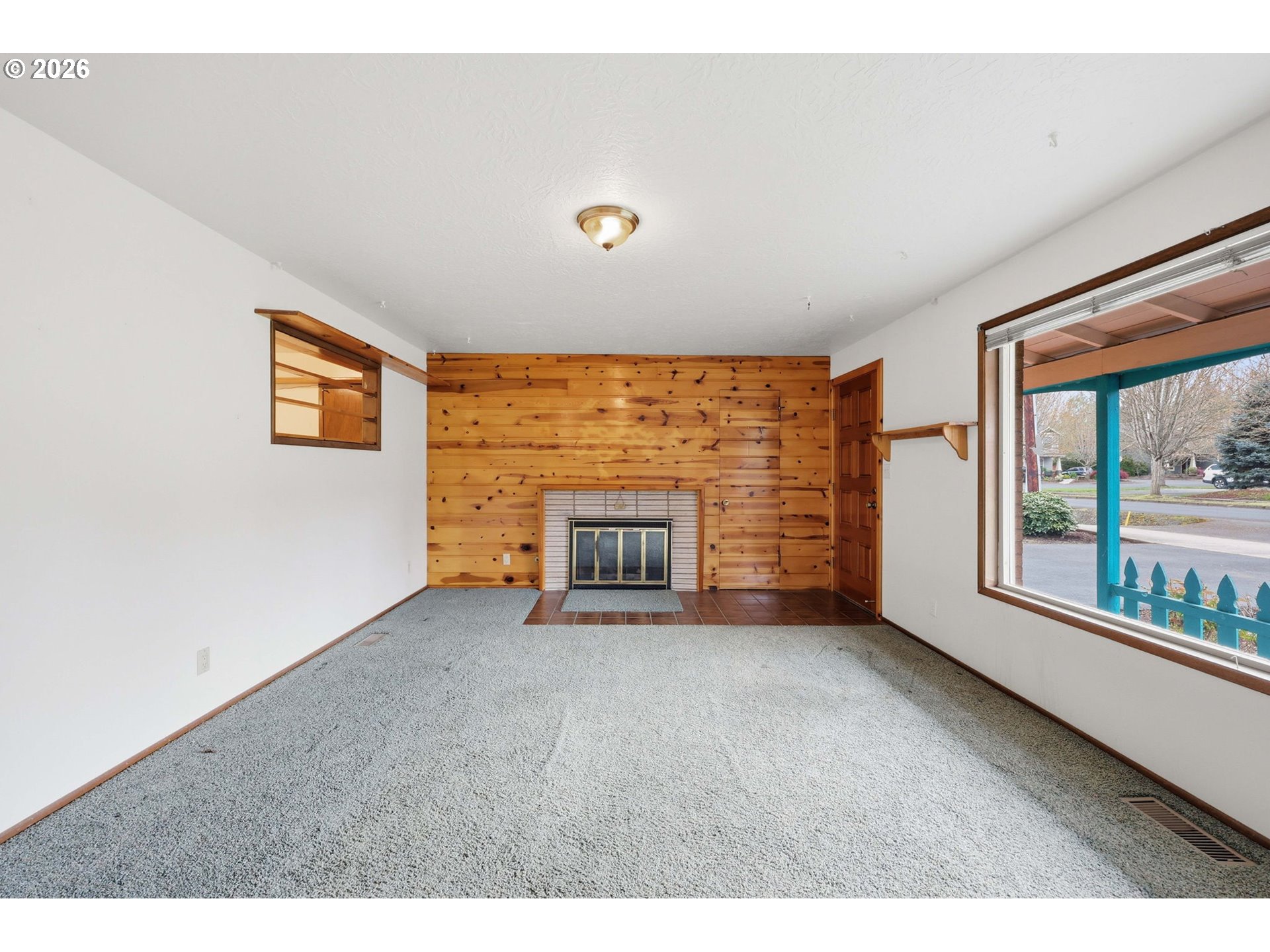 18925 Southwest Rosa Road Beaverton, OR 97078 - Photo 2 of 33 a view of an empty room with a fireplace and a window