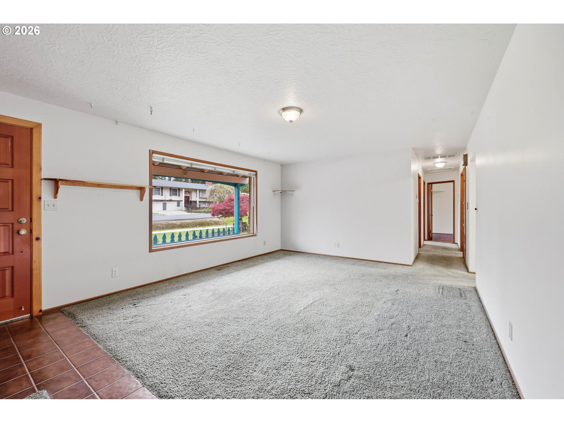 18925 Southwest Rosa Road Beaverton, OR 97078 - Photo 5 of 33 a view of an empty room with painting on the wall