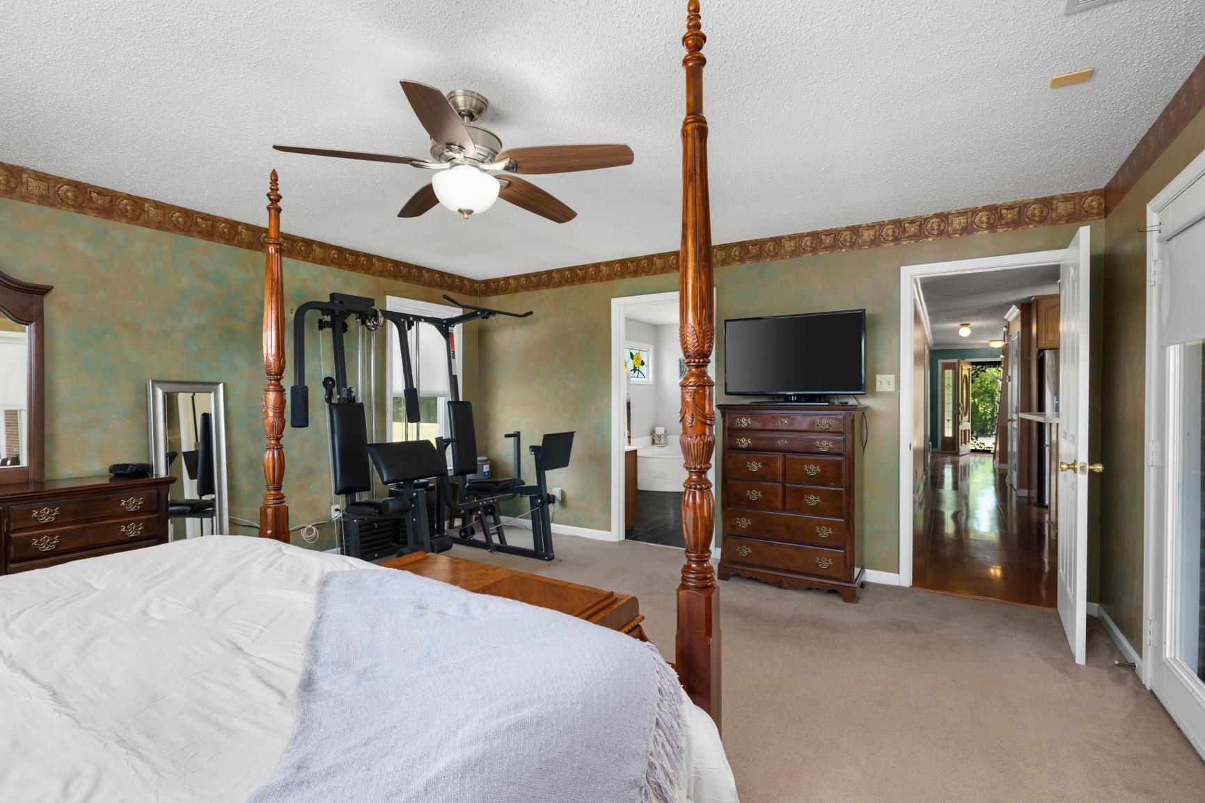 8539 Campground Road Drummonds, TN 38023 - Photo 18 of 38 a bedroom with a bed and a flat tv screen on dresser