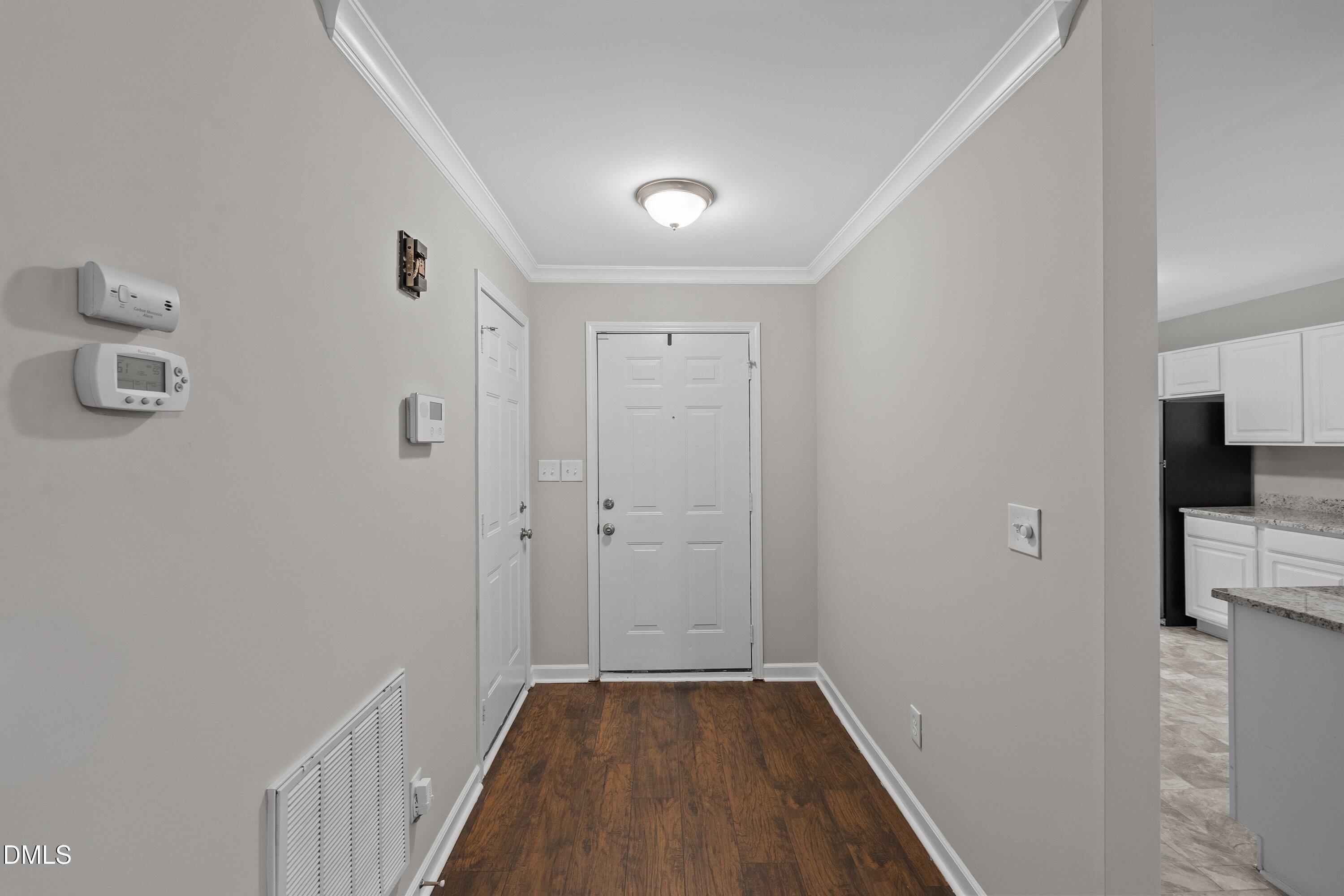 140 Melksham Road Wake Forest, NC 27587 - Photo 8 of 34 a view of a hallway with wooden floor and a bathroom