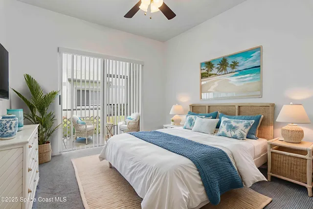 a bedroom with a large bed and a large window