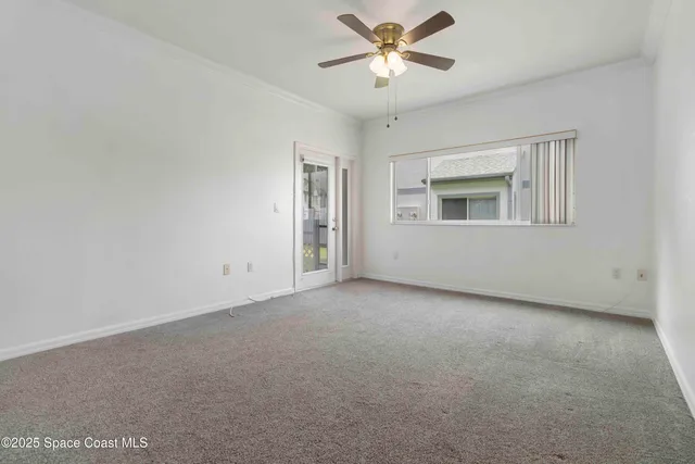 a view of empty room with ceiling fan