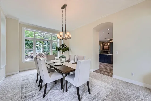 a view of a dining room and a table chairs