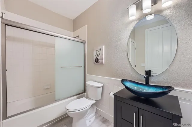 a bathroom with a toilet a sink and a mirror