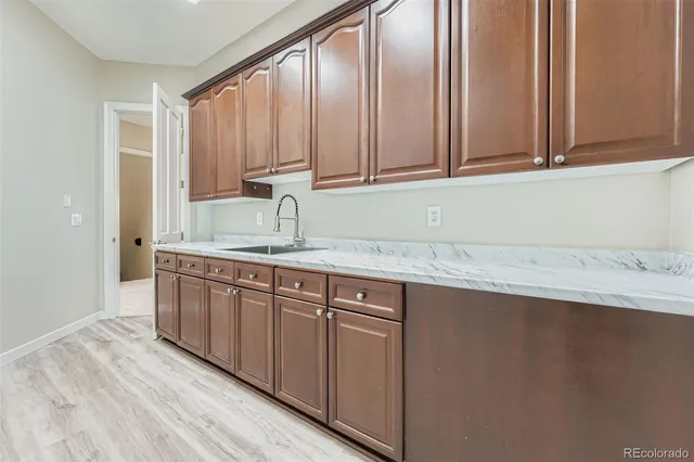 a kitchen with granite countertop cabinets stainless steel appliances and a sink