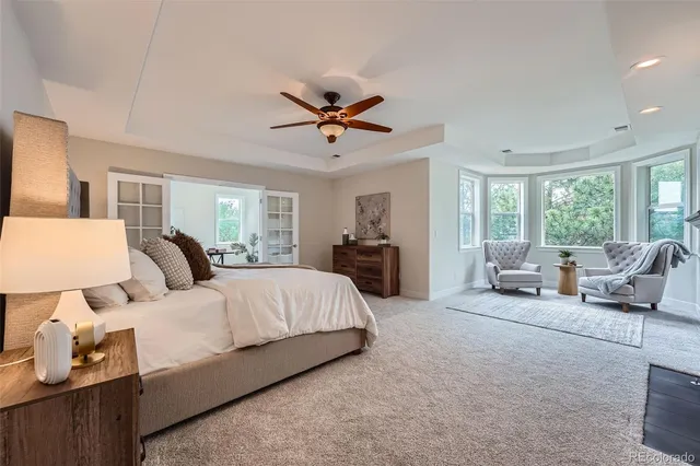 a living room with furniture and large windows