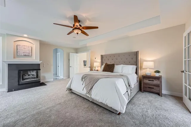 a spacious bedroom with a bed and a fireplace